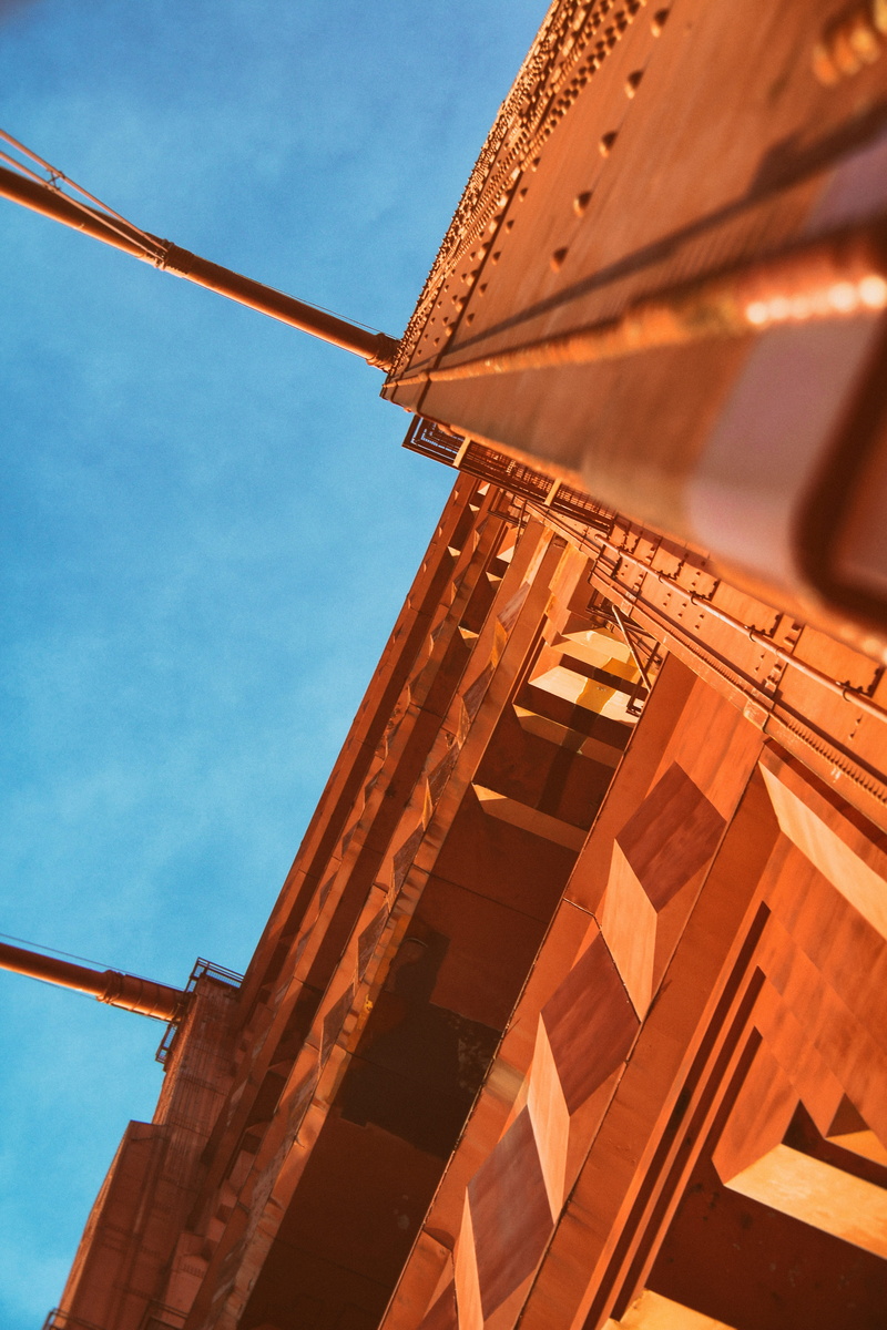 roof, infrastructure, low angle view, building exterior, bridge, building, travel destinations, nature, sunlight, built structure, blue, bay area, tall - high
