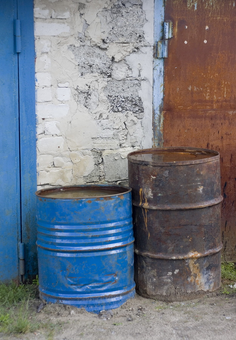 metal, no people, environment, day, container, biohazard, building exterior, cask, weathered, outdoors, rusty, drum - container, abandoned, blue, oil, old