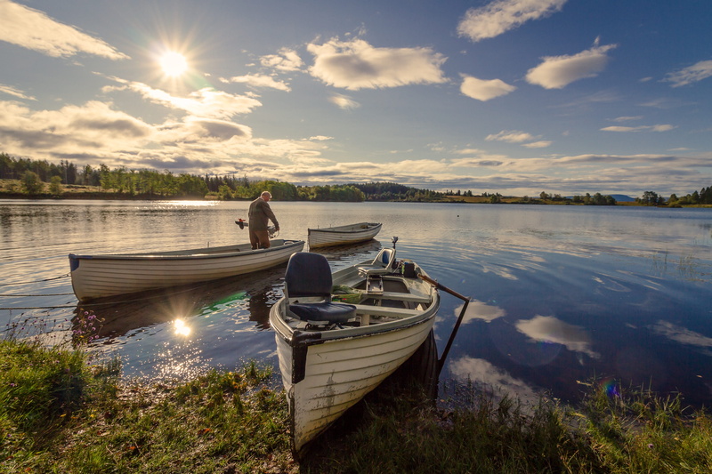 boat, sunlight, scenic, one person, daylight, vehicle, scenery, scenics - nature, grass, outdoors, lake, sunbeam, nautical vessel, fisherman, landscape