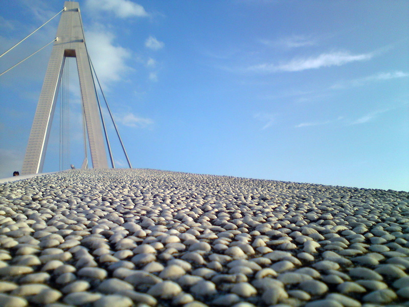 abundance, large group of objects, sunlight, famous Place, stone - object, public domain, architecture, sea, suspension Bridge, day, blue, nature, bridge - Man Made Structure