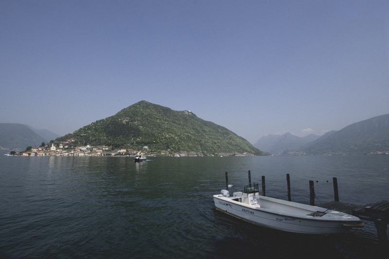 italy, sailboat, beauty in nature, lake, scenics - nature, waterfront, iseo, mountain, wooden boat, sky, moored, transportation, water, jetty, boat, island