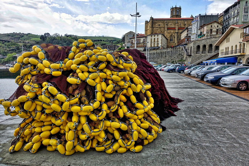 fisher, wharf, outdoors, city, architecture, incidental people, fishnet, nets, nautical, yellow, fishing nets, sky, building exterior, nature, mode of transportation