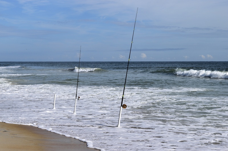 sky, equipment, scenics - nature, non-urban scene, fishing rod, shore, seaside, beauty in nature, fishing rods, beach, nature, tranquil scene, sport, coastline