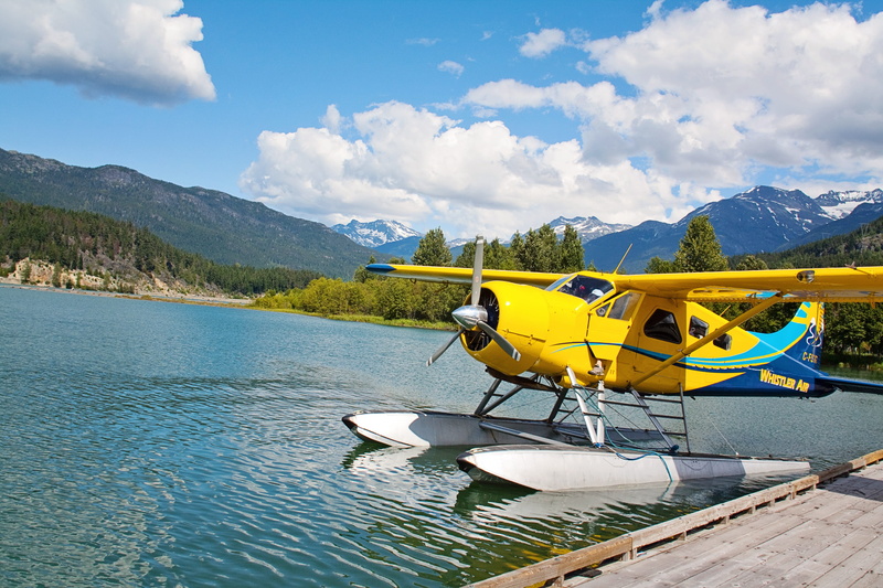 vintage, leisure activity, mode of transportation, blue, cloud - sky, one person, lake, bi plane, yellow, sea, aircraft, outdoors, aviation, airplane, nature