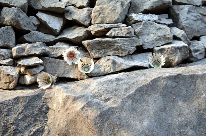 rock - object, birdie, shuttlecock, outdoors, equipment, stack, rock, birdies, day, stone, badminton, rough, shuttlecocks, nature, textured, sport, backgrounds