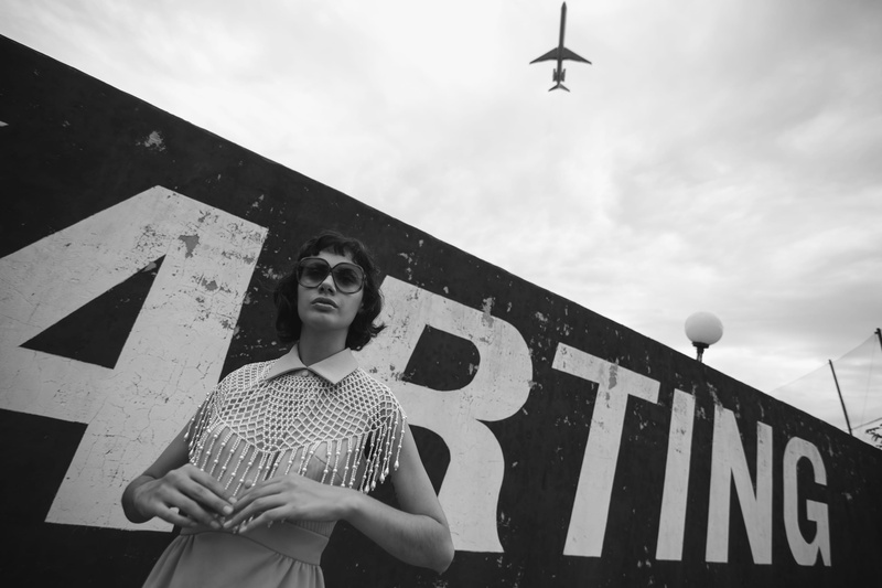 real people, plane, aviation, standing, grayscale, wear, sky, airplane, signage, casual clothing, wall, woman, air force, mode of transportation, day, leisure activity