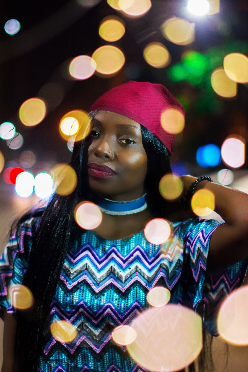 girls, childhood, night, selective, hair, person, multi colored, hat, lens flare, lights, front view, lifestyles, looking away, short, woman, holding, photography