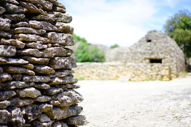 history, ancient civilization, bories, day, sunlight, nature, stone cottages, door opening, outdoors, beehive hut, rock, stack, stone wall, museum, village