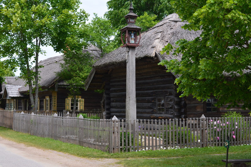 green color, plant, open air museum, building exterior, lithuania, building, village, day, countryside, built structure, tree, boundary, barrier, no people
