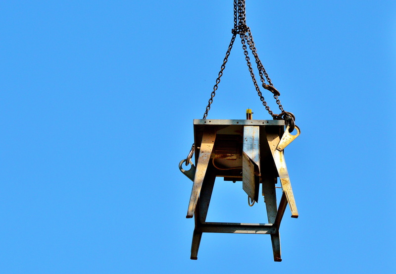 clear sky, suspended, construction site, circular saw, crane - construction machinery, saw blade, industrial equipment, site, low angle view, hanging, theft protection