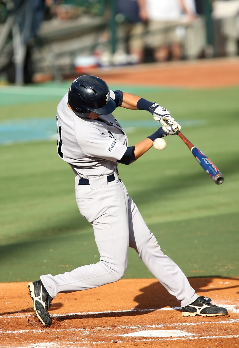 college baseball, sports uniform, hitting, helmet, real people, headwear, baseball uniform, clothing, game, full length, sports helmet, batter, focus on foreground