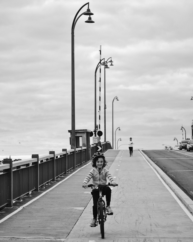 architecture, black and white, new port, outdoors, riding, it’s port adelaide, road, one person, cloud - sky, street, real people, mode of transportation