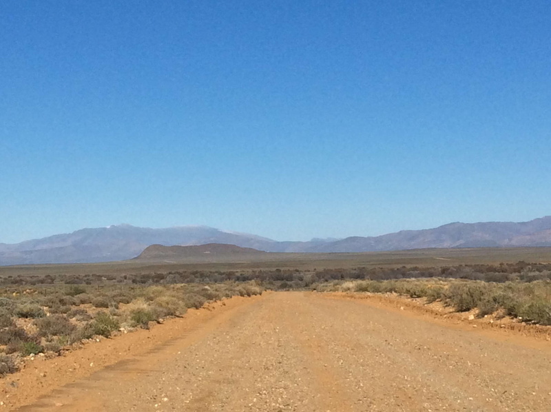 tranquility, south africa, beauty in nature, blue, landscape, climate, mountain, mountain range, outdoors, road, dirt, copy space, tranquil scene, mountains