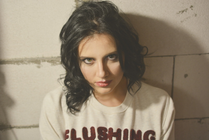 beautiful woman, black hair, real people, looking at camera, indoors, adult, wall, lifestyles, model, looking, curly hair, hairstyle, portrait, casual
