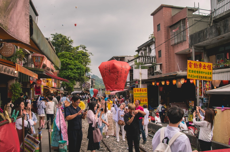 street market, selling, bazaar, travel, lanterns, group of people, rickshaw, city street, person, city, railway, large group of people, adult, men, architecture