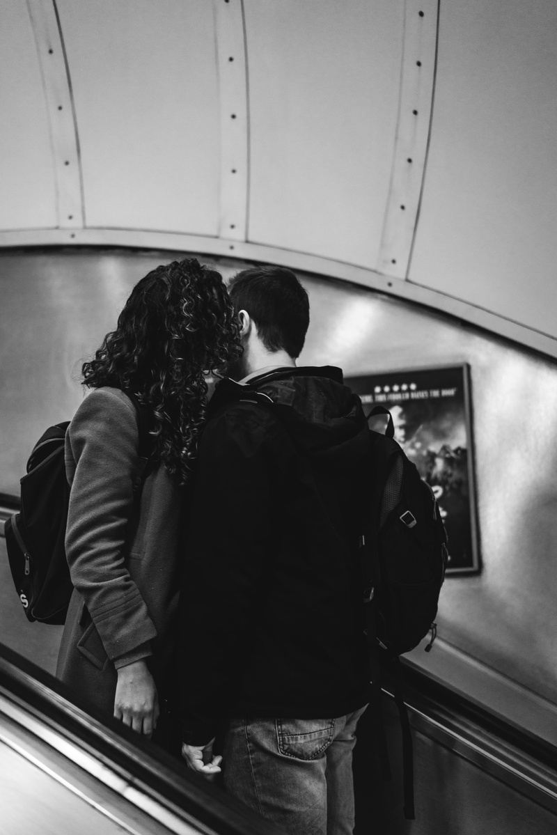 public transportation, grayscale, adult, coat, kissing, transportation, togetherness, banister, photography, make out, bag, real people, dating, couple - relationship
