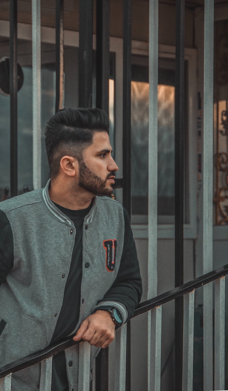 apparel, architecture, door, 2K, real people, waist up, metal, suit, pedestrian, young men, prison, looking, railing, facial hair, casual clothing, near