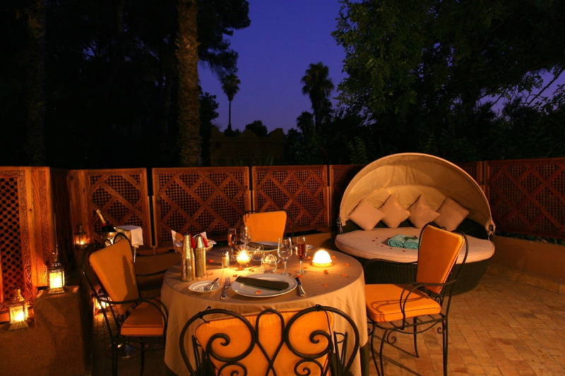 food and drink, restaurant, candle, architecture, decoration, lighting equipment, flame, formal, setting, brown, outdoors, electric lamp, luxury, outdoor