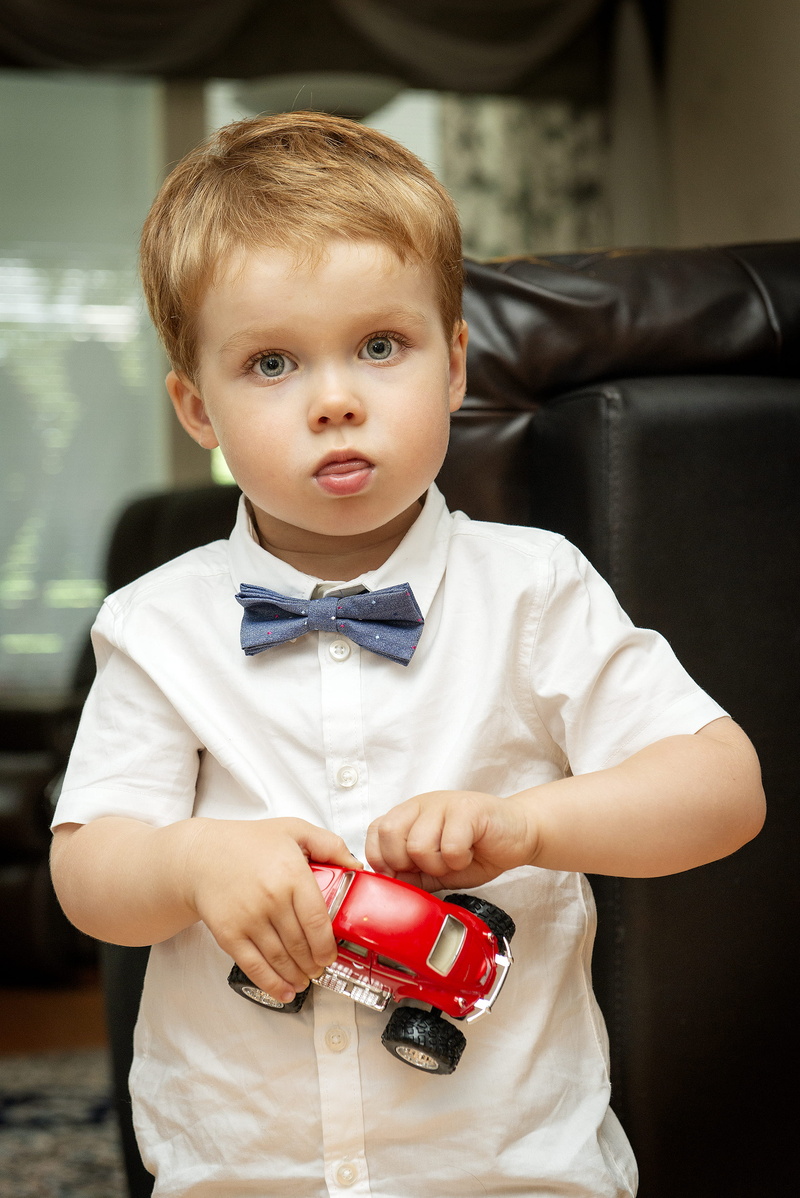 vehicle, portrait, red, son, casual clothing, men, child, indoors, real people, holding, boy, little, little boy, childhood, button, cute, innocence, shirt