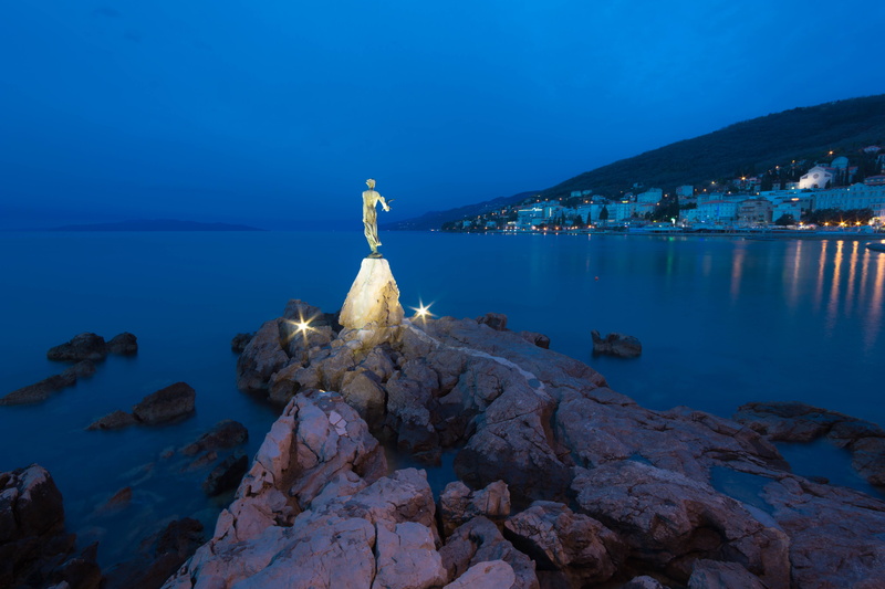 robe, blue, outdoors, rock - object, sea, city, gown, evening dress, art and craft, morning, sculpture, standing, nature, illuminated, mountain, no people