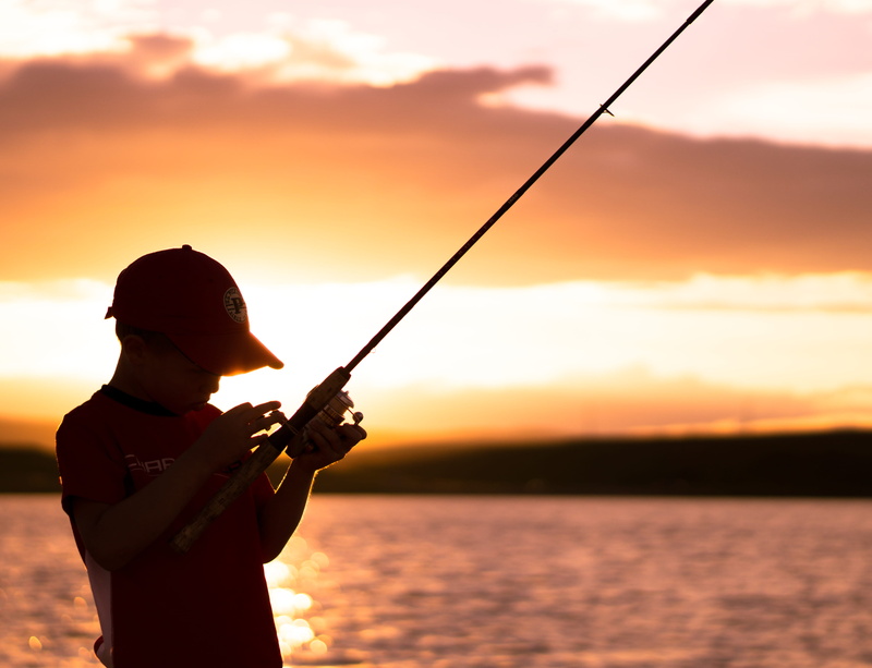 fishing rod, real people, activity, orange color, sun, lake, standing, leisure activity, one person, silhouette, nature, sunset, sky, outdoors, lifestyles