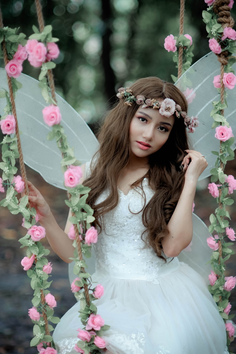 real people, facial expression, fairy, portrait, hair, flower crown, looking at camera, flowers, pretty, headwear, one person, plant, glamour, young women