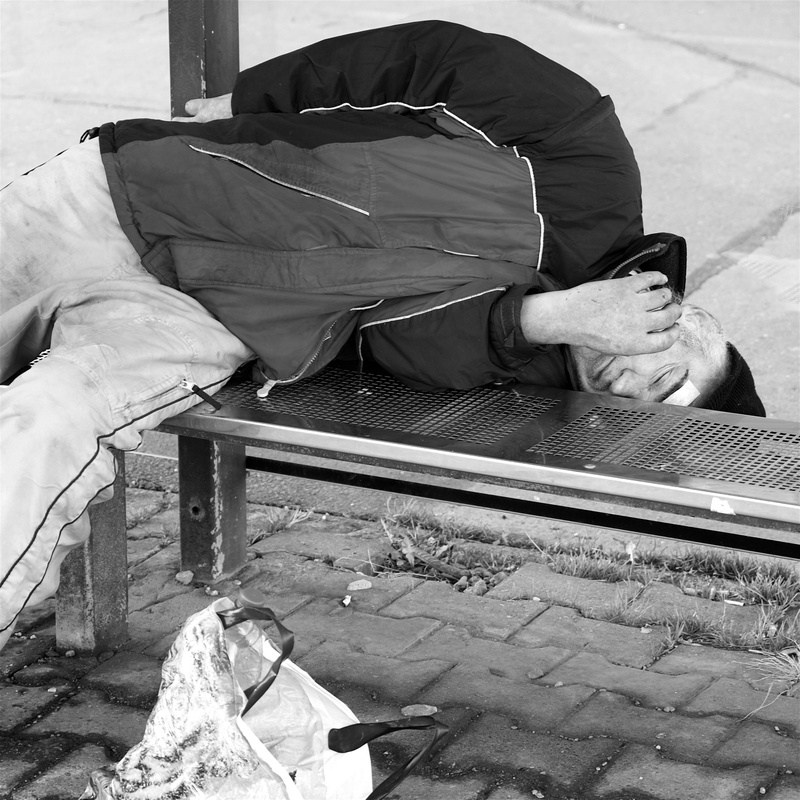 problems, high angle view, street, bag, society, real people, hopelessness, plastic bag, footpath, lifestyles, relaxation, one person, city, social issues