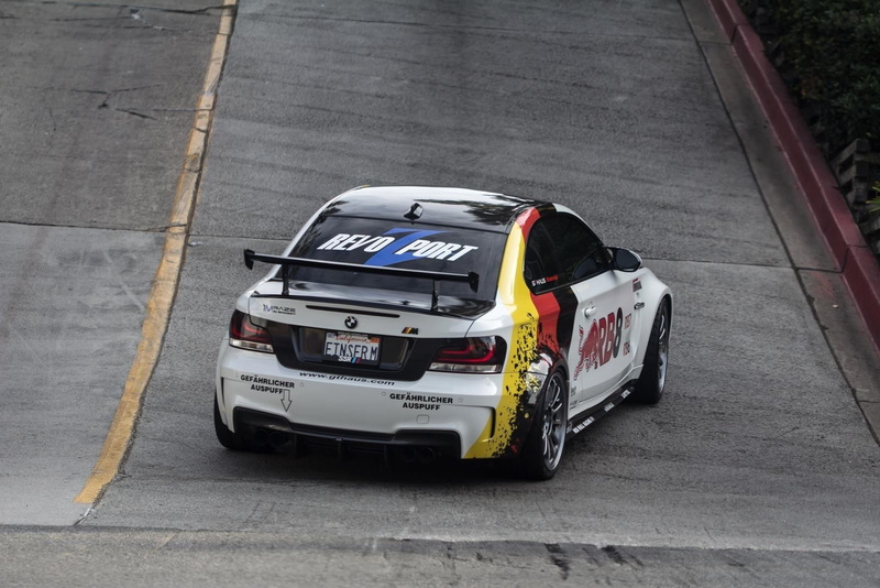 bmw m1 coupe raze car, sport, high angle view, road, auto racing, motor vehicle, outdoors, street, car, transportation, day, sports race, people, motor racing track