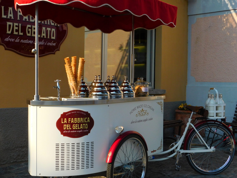 2K, nature, western script, city, ice cream parlor walking, day, building exterior, business, outdoors, communication, text, bicycle, architecture, cream