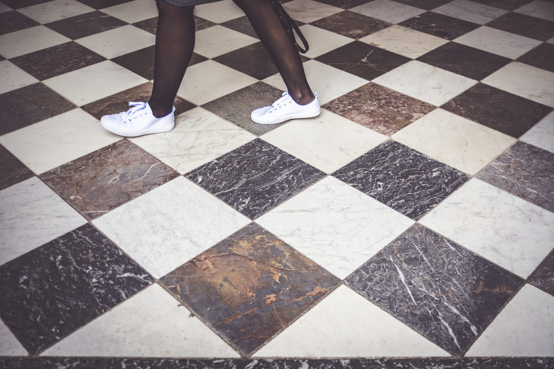 white, floor, rug, person, top, pattern, human foot, body part, wearing, leisure activity, pair, one person, chess, versailles, low section, standing, footwear