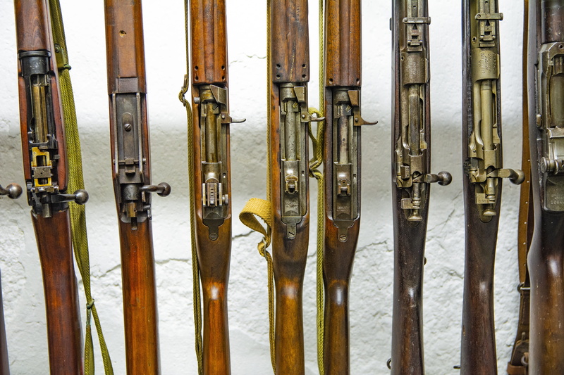no people, side by side, guns, barrier, in a row, security, handgun, cannon, group of objects, 5K, close-up, wood - material, weapon, metal, backgrounds