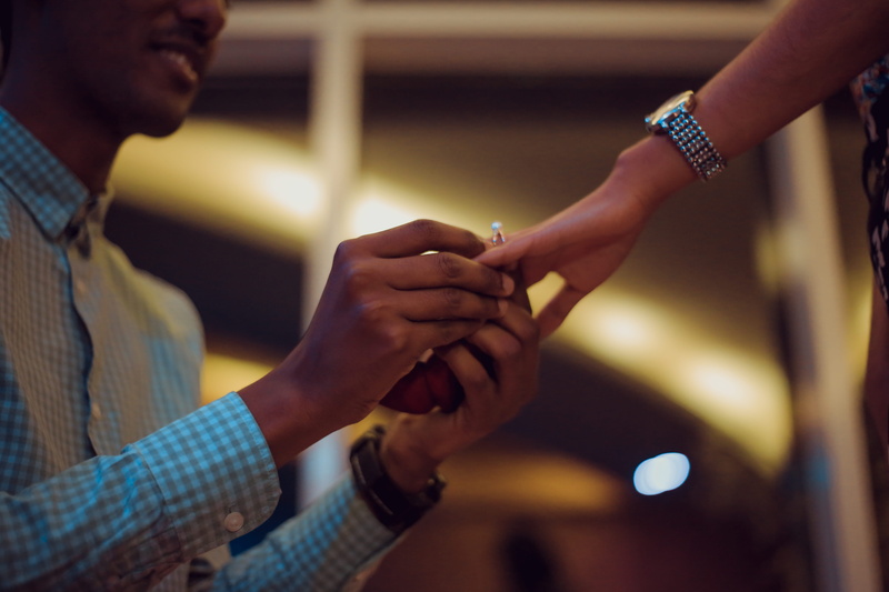 man, positive emotion, holding hands, togetherness, event, engagement, person, propose, kneeling, couple - relationship, ring, banister, people, flight