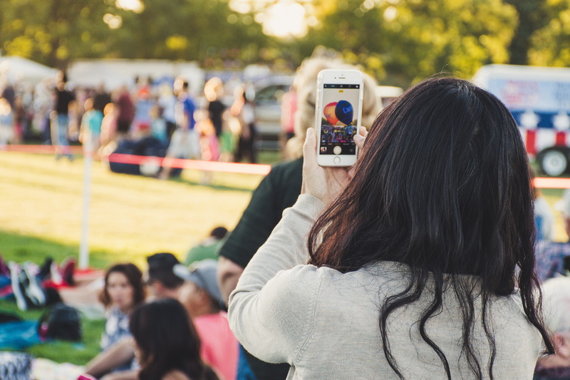 daylight, back view, photographing, selective focus, wireless technology, holding, adolescence, adult, arts culture and entertainment, leisure activity