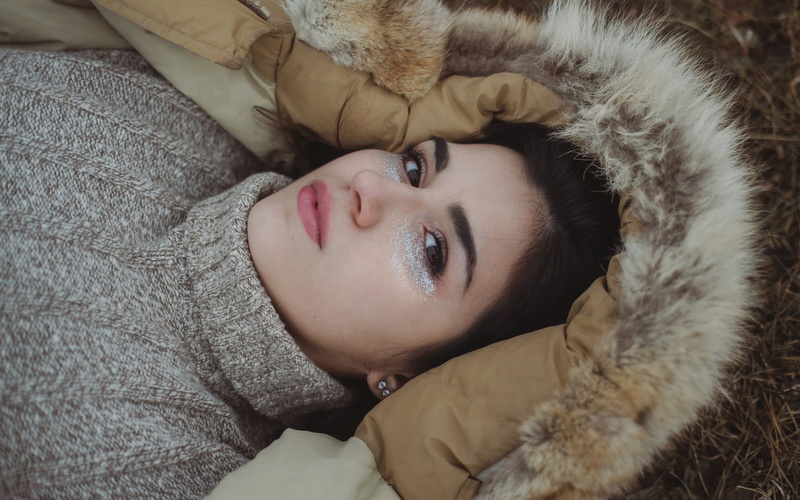 makeup, women, brunette, 1080P, brown eyes, pale, hoods, sweater, looking at viewer, lying on back