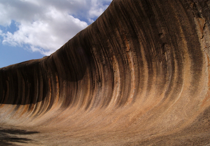 table, landscape, low angle view, waves, cloud - sky, outdoors, tranquility, clouds, chairs, environment, textured, wall, wooden, erosion, beauty in nature