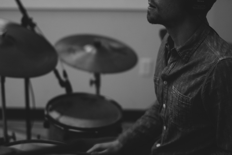 percussion, equipment, musician, indoors, grayscale, drummer, playing, artist, performance, cymbals, instrument, band, man, skill, musical, casual clothing