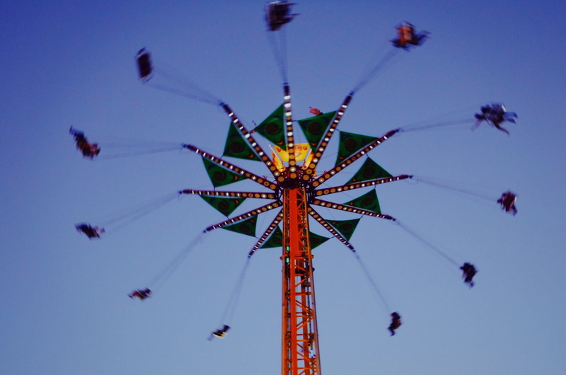 festival, chain swing ride, carnival, fairground, enjoyment, amusement, amusement park, swing, tall - high, fun, theme park, sky, outdoors, blue, motion