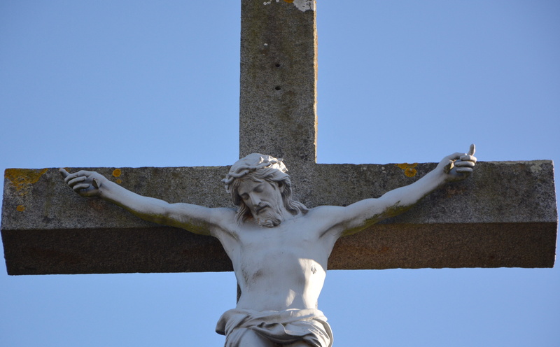 low angle view, male likeness, religious monument, sculpture, religion, crucifix, sky, human representation, creativity, building, brittany, blue sky, architecture