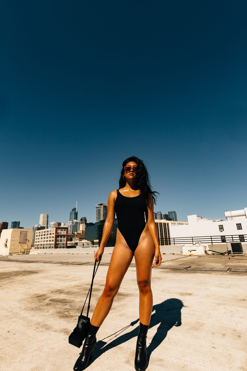 model, leisure activity, la, portrait, black, looking at camera, bodysuit, leotard, outdoors, day, hairstyle, fashion, bag, 4K, beautiful woman, full length