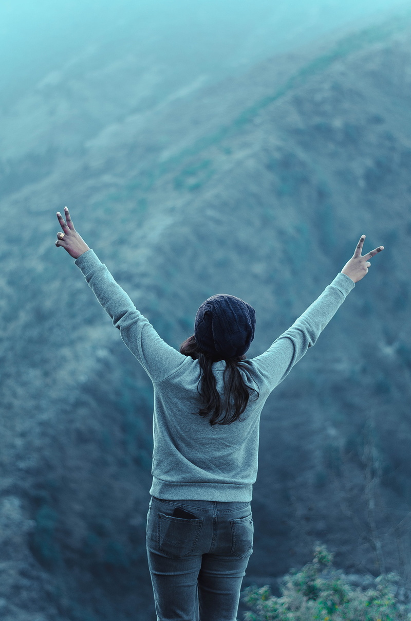 casual clothing, adult, day, three quarter length, focus on foreground, rear view, arms raised, human arm, leisure activity, lifestyles, sign, women, freedom