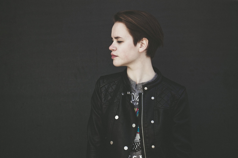 model, beautiful, wearing, black background, leather jacket, standing, woman, girl, beautiful woman, indoors, casual clothing, side, looking, lifestyles