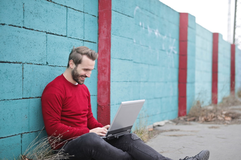 25-30 years, men, sky, beard, knees, connection, young, boundary, internet, floorcaucasian, casual clothing, red, 2K, technology, smilingly, screen, facial hair