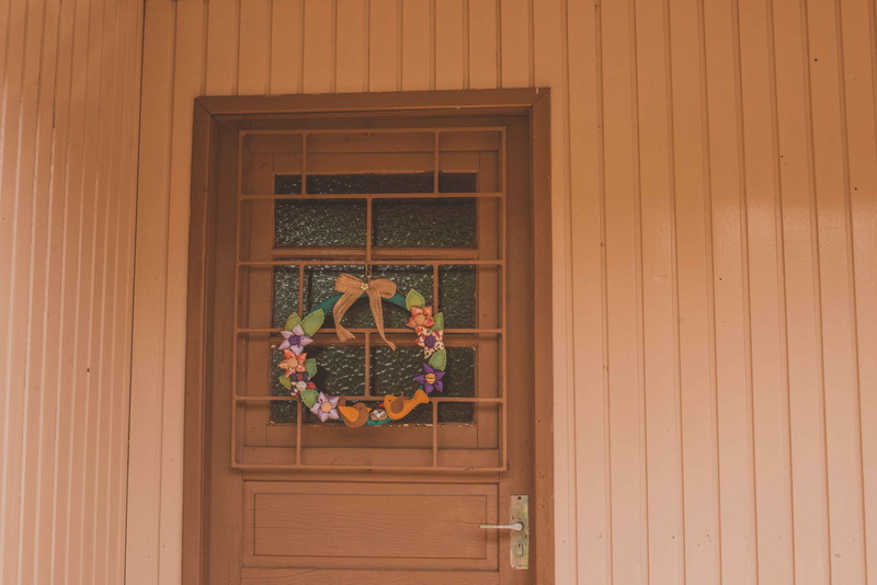 wreath, home decor, nature, closed, plant, roof, door, fern, curtain, entrance, built structure, food, outdoors, sunflower, potted plant, window frame