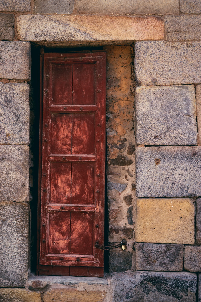 cobblestone, sidewalk, building, stone wall, path, slate, rust, flower, window, curtain, no people, walkway, protection, security, flagstone, outdoors