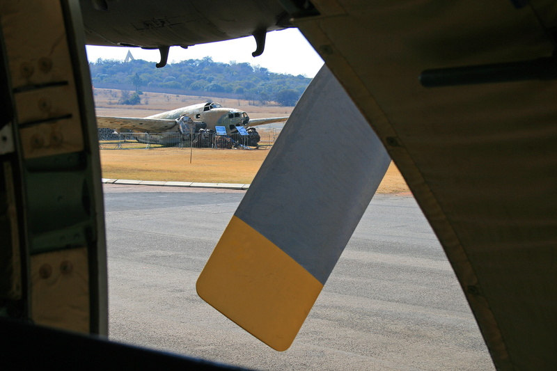 airplane, propeller, windshield, day, men, road, airport, nature, tarmac, display, glass - material, bays hill, yellow, fixed wing, heritage, static, transportation