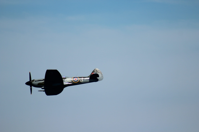 transportation, low angle view, transport, historic, spitfire, outdoors, air vehicle, fighter plane, war, mid-air, motion, blue, cockpit, fighter, battle of britain