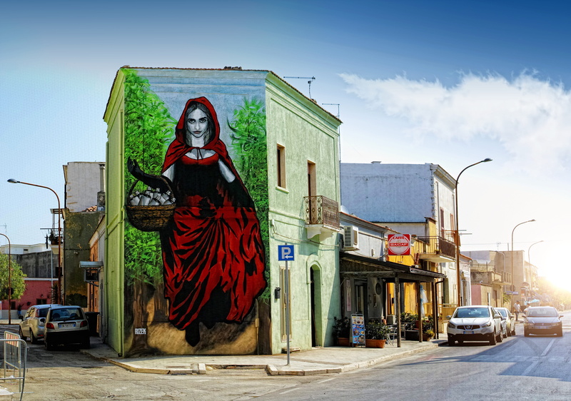 5K, sky, female, mode of transportation, art and craft, red, street artist, human representation, outdoors, representation, color, woman, building, nature