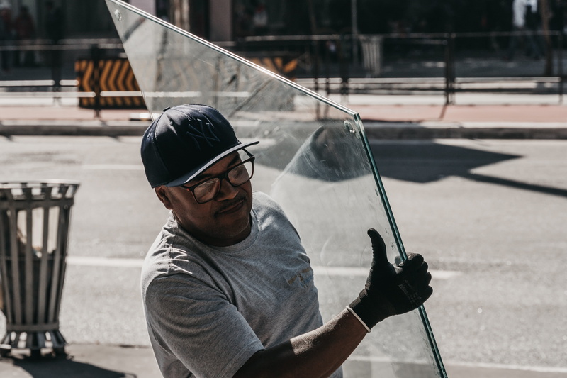 headshot, glass, holding, sunlight, day, apparel, one person, males, outdoors, human, real people, carrying, lifestyles, hat, focus on foreground, cap