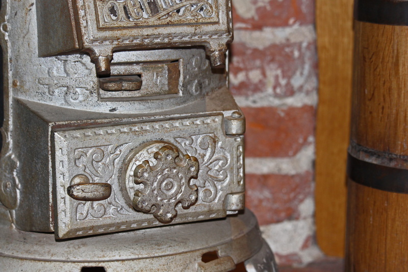 indoors, metal, history, cast iron, oven, nostalgia, museum piece, architecture, antiquity, focus on foreground, formerly, pattern, floral pattern, creativity