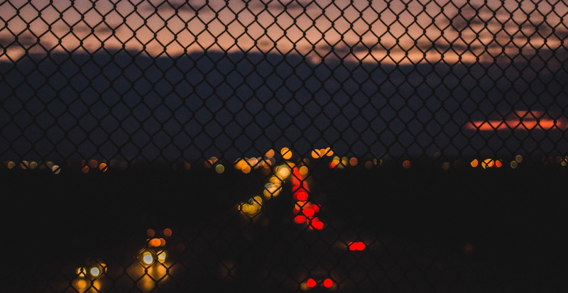 sky, glowing, no people, road, nature, fence, red yellow, lights, city lights, orange color, artisitic, celebration, blurr, outdoors, yellow, pink coulds